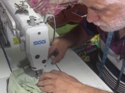 بعد تدمير مشغله.. خياط من ذوي الإعاقة السمعية يعود إلى العمل